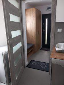 a door leading into a room with a kitchen at Domek Pod Prehybą -Agroturystyka in Gaboń