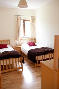 a bedroom with two beds and a window at Castle Quay Holiday Homes in Ballinadee