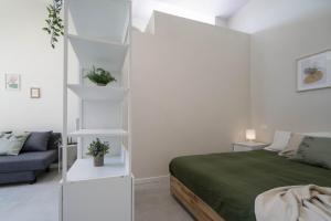 a bedroom with a bed and a white book shelf at casadelfalegname ABETE 