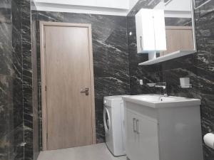 a bathroom with a toilet and a sink and a mirror at Katerina's Relaxing Apartment in Sarandë +19 photos