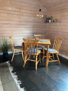 a wooden table and two chairs and a table and a table and chairs at Fishermans cabin in Lofoten, Stamsund in Stamsund
