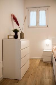 a bedroom with a dresser and a bed at VILLA AMBROSIA 172 A in Terracina