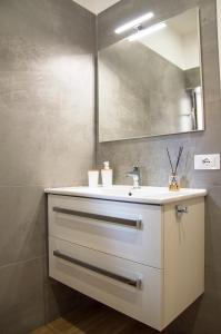 a bathroom with a white sink and a mirror at VILLA AMBROSIA 172 A in Terracina