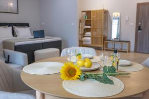 ブルガスにあるДизайнерско Студио в Модерна сграда -Молимаркс Делукс Студио Бургасのリビングルーム(ひまわり付きの木製テーブル付)