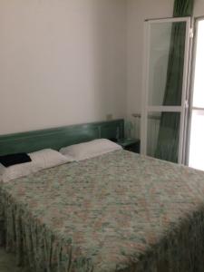 Voodi või voodid majutusasutuse Albergo Olmitello - cucina vegetariana bio e tradizionale toas