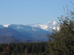 a view of a mountain range with snow covered mountains at Cabane dans les bois avec vue sur les Pyrénées in Saint-Laurent-de-Neste