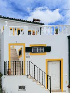Vale de ColmeiasにあるCasa da Avó Teresaの階段と旗のある白い家