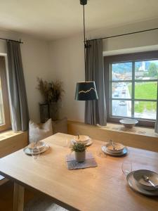 a wooden table with plates and dishes on it at Ferienwohnungen Peisserhof in Sillian +41 photos