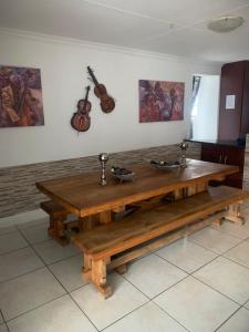 a wooden table with two faucets on a wall at Rustic red in Benoni