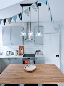 a kitchen with a wooden table with a plate on it at City Boho Loft Apartment Free Parking in Brighton & Hove
