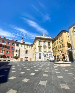 a city square with buildings and a blue sky at Duplex Cosy au Cœur du Vieux-Nice in Nice