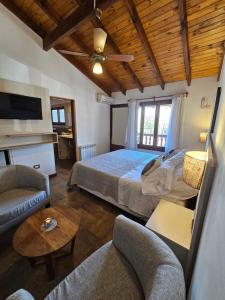 a bedroom with a bed and a living room at Posada Aitue in Villa General Belgrano +107 photos