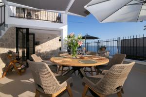 a dining room with a table and chairs at Villa Bella Vista Heritage Oasis in Podstrana