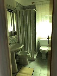 a bathroom with a toilet and a sink at Villa Dacla in Lampedusa