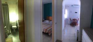 a small room with a bed and a room with a hallway at Villa Dacla in Lampedusa