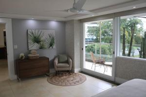 a bedroom with a chair and a sliding glass door at PU4A Big Apt Overlooking Parque Urraca City Center in Panama City