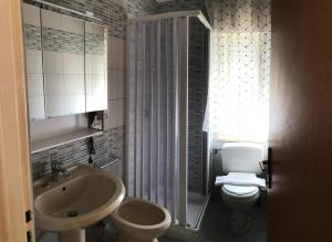 a bathroom with a sink and a toilet and a shower at Villa Dacla in Lampedusa
