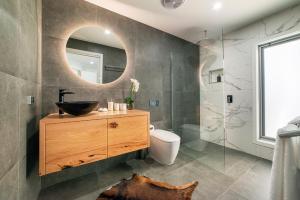a bathroom with a sink and a mirror at Heath House Luxury Halls Gap Accommodation in Halls Gap +20 photos