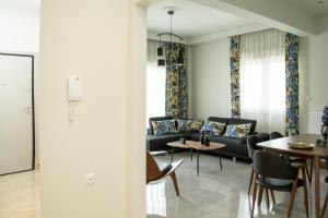 a living room with a couch and chairs and a table at City Chic Apartment in Volos