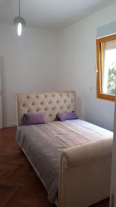 a bedroom with a large bed with purple pillows at Multiverse in Podstrana +163 photos