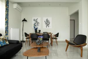 a living room with a table and chairs at City Chic Apartment in Volos