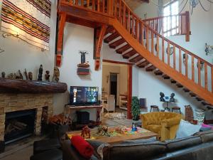 a living room with a couch and a staircase at Ikamu's lodge in Germiston