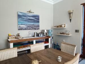 een eetkamer met een houten tafel en stoelen bij Ikamu's lodge in Germiston