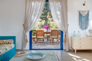 a living room with a table and chairs at To Pyrgaki Kos in Kos