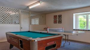 a room with a pool table and a table at 4 Seasons at Beech Mountain in Beech Mountain