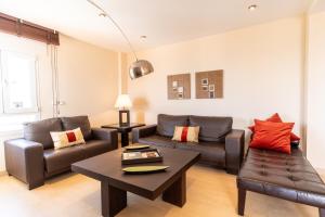 a living room with a couch and a table at Trendy Homes Almerimar Seaview Penthouse in Almerimar