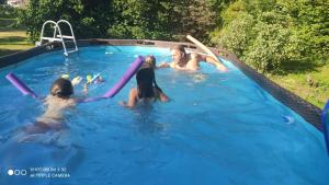 Eine Gruppe Mädchen, die im Schwimmbad spielen in der Unterkunft Petit coin de Paradis in Fontaine-lès-Luxeuil