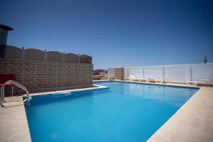 a swimming pool on the roof of a building at Appart Hotel Star in Tangier