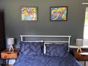 a bedroom with a bed and two pictures on the wall at Unique English Heritage Escape in *Bembridge* IOW in Bembridge