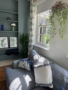 a living room with a couch and a window at Unique English Heritage Escape in *Bembridge* IOW in Bembridge