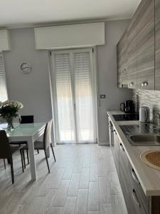 a kitchen with a table and a dining room at Residenza Al SoGno - on Lake Garda in Cavaion Veronese