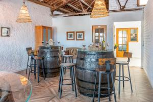 a wine tasting room with two wine barrels and stools at Casa Rural l'Olivera - Ideal para Retiros, Familias y Amigos - Cerca de Morella y Peñíscola - Mínimo 2 noches in Sant Mateu