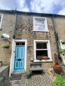 a brick house with a blue door and a window at Rural Yorkshire Getaway - Modern Victorian Cottage, Long term stay offers, message direct in Luddenden Foot