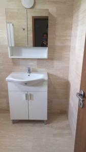 a bathroom with a white sink and a mirror at Casa Loredana in Mangalia