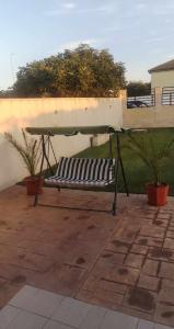 a black and white bench sitting on a patio at Casa Loredana in Mangalia +1 photo
