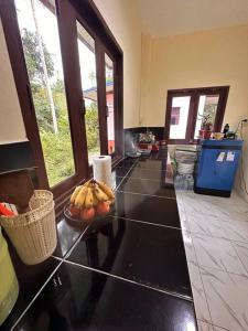 a kitchen with a bowl of fruit on a counter at Cozy Garden House in Kohphangan! in Ban Nua