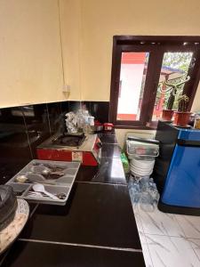 a kitchen with a black counter top and a sink at Cozy Garden House in Kohphangan! in Ban Nua