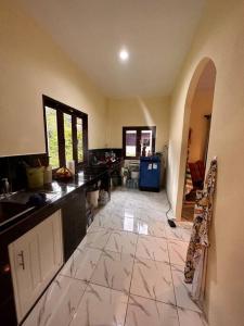 a large kitchen with a large tile floor at Cozy Garden House in Kohphangan! in Ban Nua