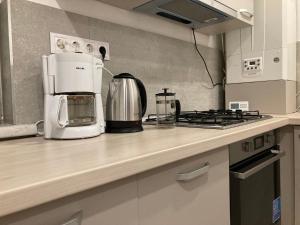 a kitchen counter with a coffee maker and a microwave at My Holiday Apartment Sibiu in Sibiu