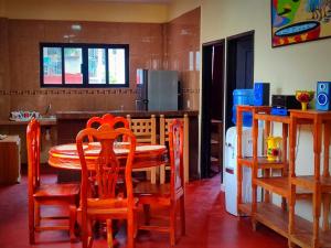 a kitchen with a table and chairs and a kitchen with a counter at DEPARTAMENTO EL PARAISO in Xilitla