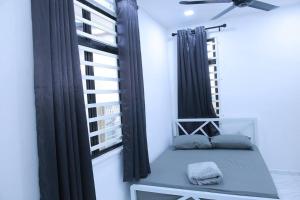 a window seat in a room with black curtains at Green Dream Homestay 3 Kota Bharu 3 Aircond Room With Wifi & Netflix in Kota Bharu
