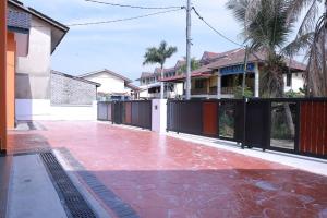 an empty courtyard of a house with a fence at Green Dream Homestay 3 Kota Bharu 3 Aircond Room With Wifi & Netflix in Kota Bharu