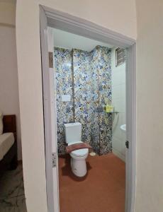 a bathroom with a toilet and a shower at 88 Backpackers Hua Hin in Hua Hin