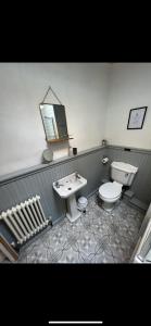 a bathroom with a sink and a toilet and a mirror at Rural Yorkshire Getaway - Modern Victorian Cottage, Long term stay offers, message direct in Luddenden Foot