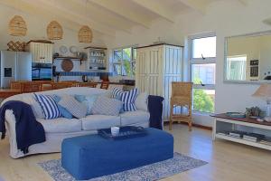 a living room with a couch and a table at Paradise@Pearly in Pearly Beach