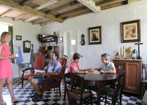 a group of people sitting around a table playing chess at Barak de Vinck - guesthouse in Ieper
